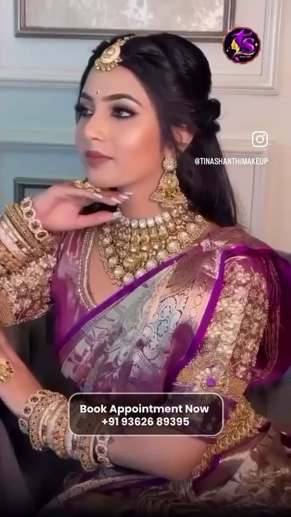 Bride in a purple silk saree with temple jewellery